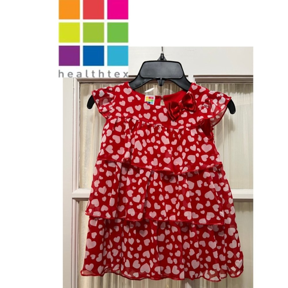 Healthtex red tiered top; white hearts print; satiny bow at the neck.